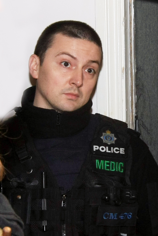 The police officer who raided the squat wearing a pistol