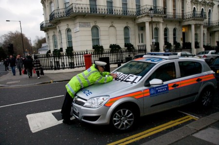 Policeman rearranging PEACE into CAPE! on his car