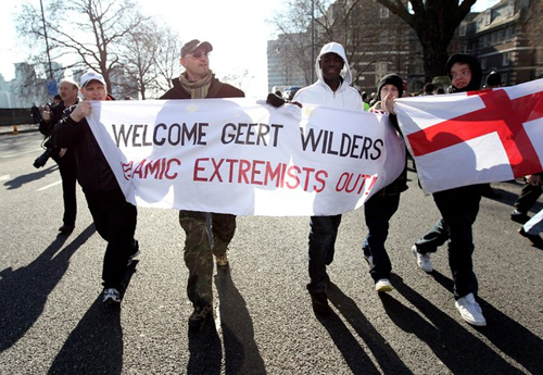 "Welcome Geert Wilders" with non-white EDL supporter
