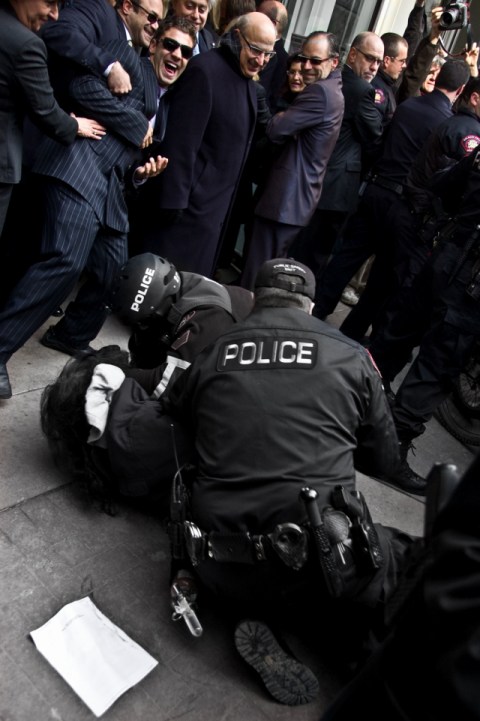 Canadian police arresting Splitting the Sky after his attempt to arrest Bush
