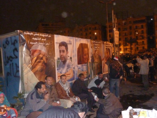 Occupiers bedding down next to pictures of the martyrs