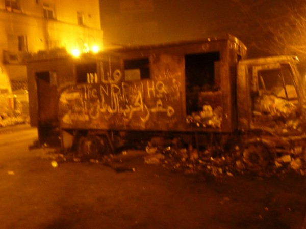 Burnt out vehicle used as a barricade - Tahrir Square 08/02/2011