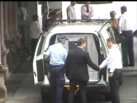 Daniel Hietbrink shakes hands with fellow policeman
