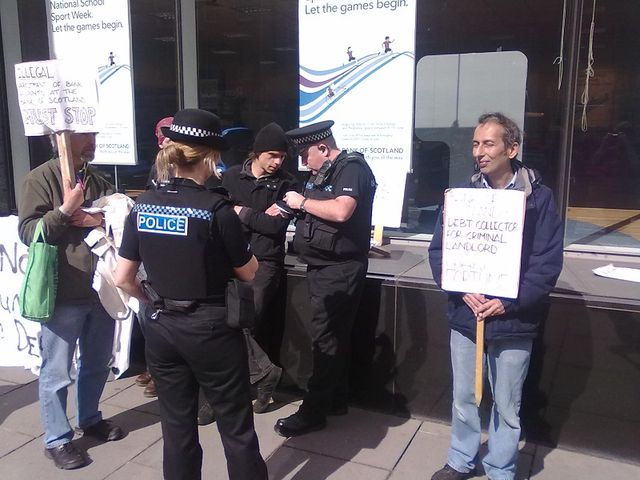 One protester enjoys the scottish sun and the chirp-chirp of the summer police