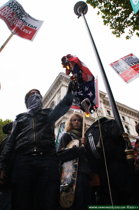 Flag of imperialist power up in flames