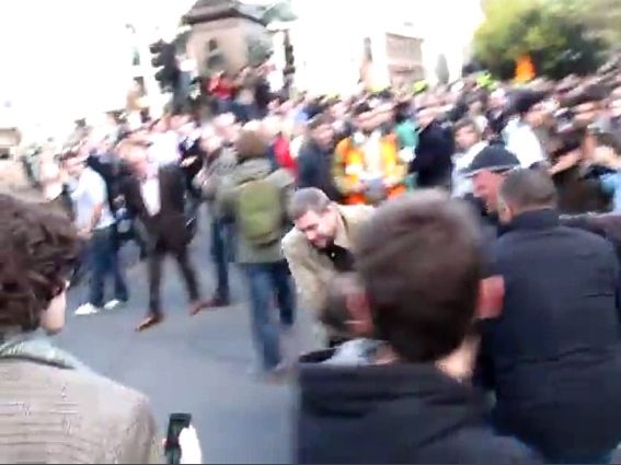 Brown jacket and 3 more thugs struggle to floor 1 skinny lad...