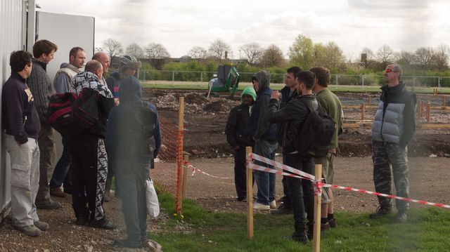activists talk to workers on site