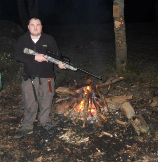 Scott 'Bomber' Wright wielding a gun (possibly an air rifle)