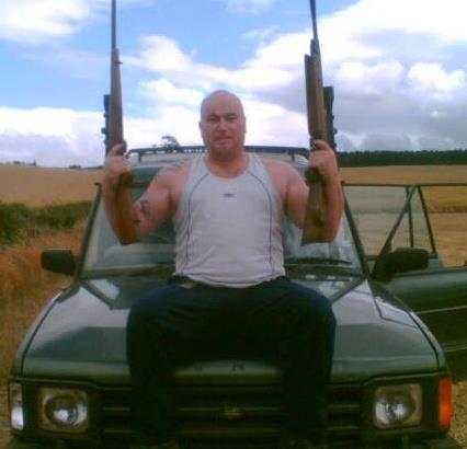 Norman Crannage posing with weapons