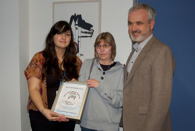 Amnesty presents Susan with a human rights award for Chelsea from schoolchildren