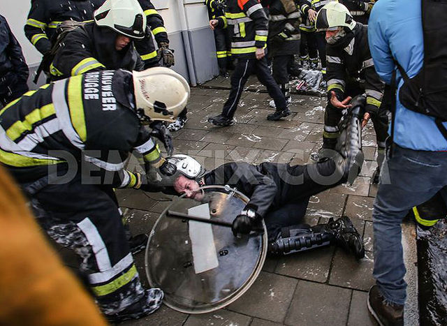 Belgian fire-fighters take down riot cop!