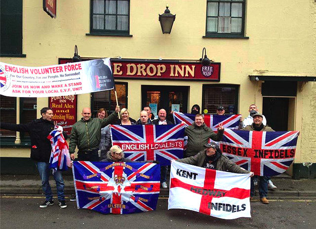 Same Nazi in group posing next to EVF banner