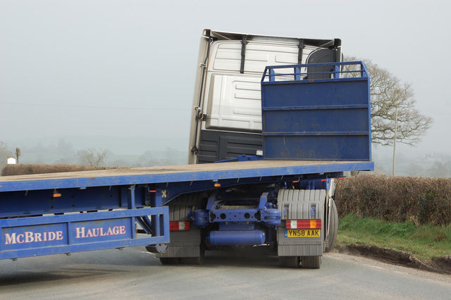 Truck is unable to turn onto main road without damaging verge on far side