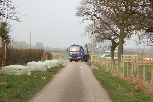 The truck back up by the site gate where there's room for the car to pass