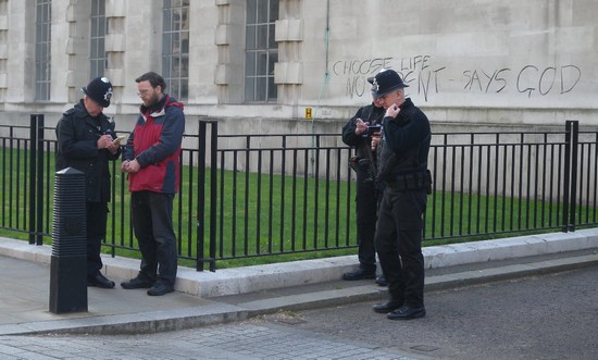 Fr Martin being arrested after daubing message in ash on Ministry of Defence
