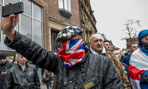 Henry Green masked with Union Jack flag at Pegida march in Newcastle